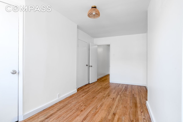 unfurnished bedroom with light wood-style floors and baseboards
