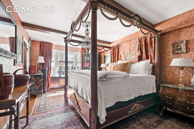 bedroom featuring wallpapered walls and wood finished floors
