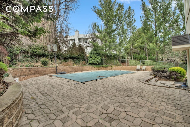 view of swimming pool with a fenced in pool, fence, and a patio