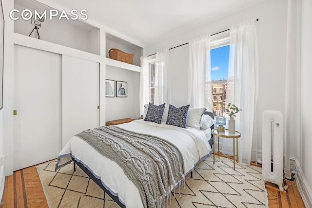 bedroom featuring radiator and a closet
