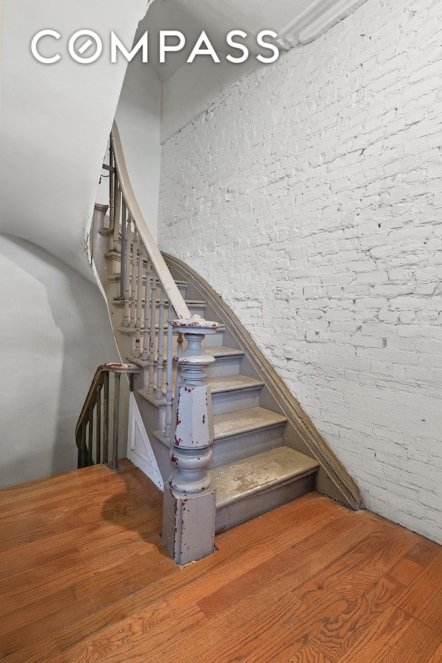 staircase featuring wood finished floors