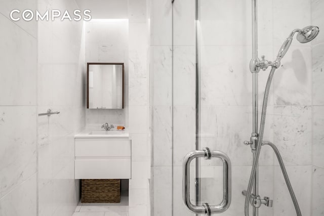 138 E 36th St Unit 4C, New York City, NY 10016 - bathroom with tile walls, a stall shower, and vanity