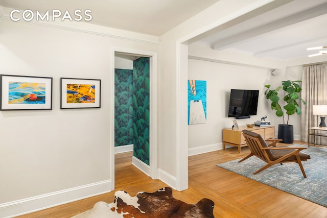 138 E 36th St Unit 4C, New York City, NY 10016 - living room featuring wood finished floors, beamed ceiling, and baseboards