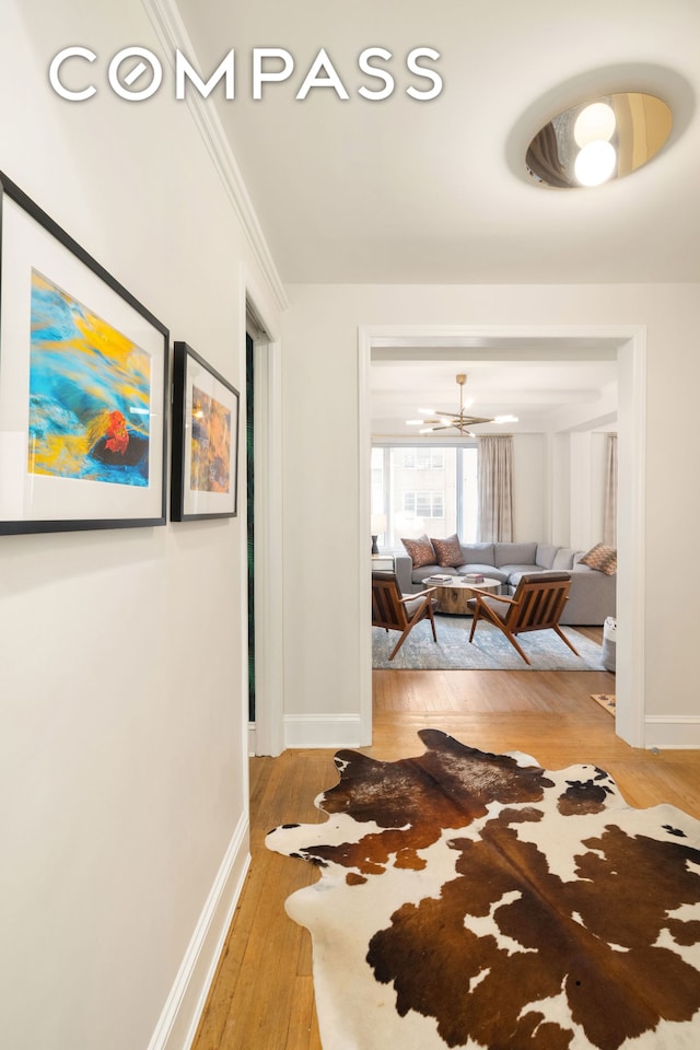 138 E 36th St Unit 4C, New York City, NY 10016 - corridor featuring light wood-style floors, baseboards, and a chandelier