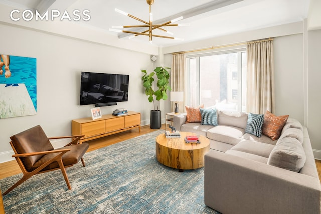 138 E 36th St Unit 4C, New York City, NY 10016 - living area with wood finished floors, baseboards, and a chandelier