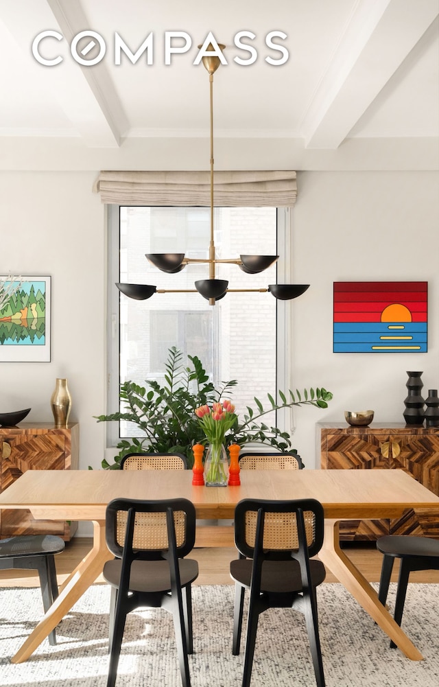 dining room featuring beamed ceiling and wood finished floors