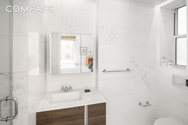 bathroom featuring toilet, tile walls, decorative backsplash, and vanity