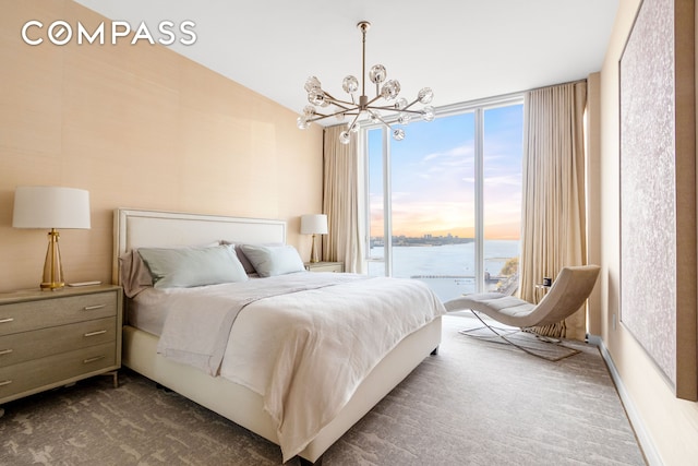 10 Riverside Blvd Unit 28C, New York City, NY 10069 - bedroom with dark carpet, access to exterior, and a chandelier