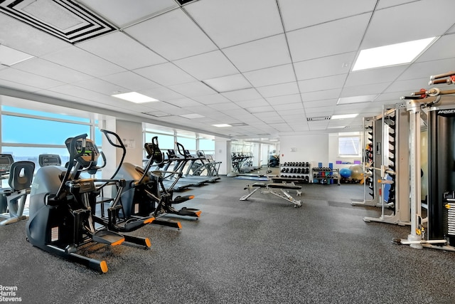 gym with a drop ceiling and visible vents