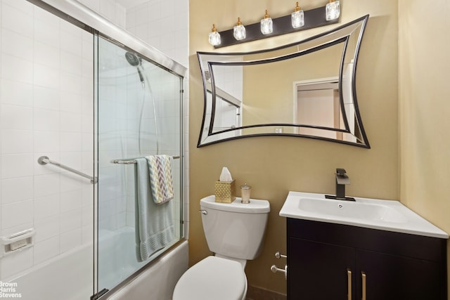 bathroom featuring shower / bath combination with glass door, toilet, and vanity