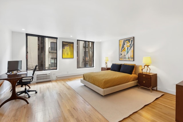 bedroom with recessed lighting and wood finished floors