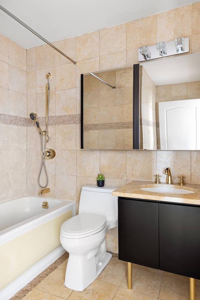 bathroom with vanity, toilet, tile walls, bathtub / shower combination, and tasteful backsplash