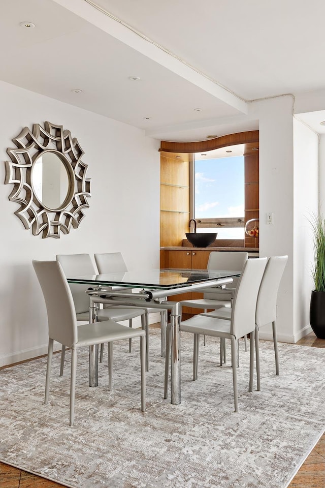 dining area featuring baseboards and wood finished floors