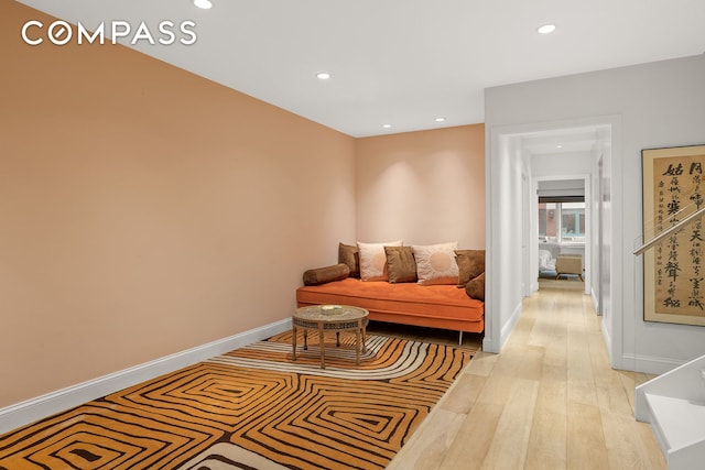 sitting room featuring baseboards, recessed lighting, and light wood-style flooring