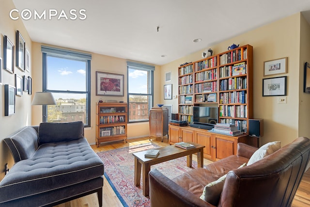 sitting room featuring light wood finished floors and visible vents