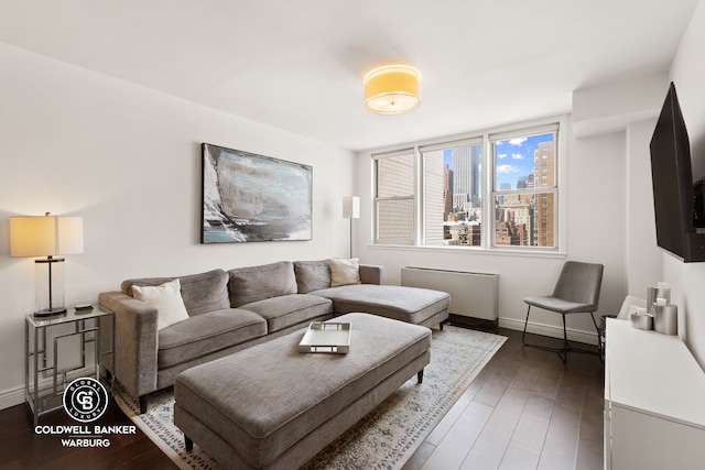 living area featuring baseboards and hardwood / wood-style floors