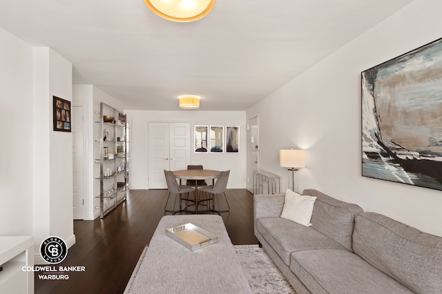 201 E 36th St Unit 17D, New York City, NY 10016 - living room featuring dark wood-type flooring and baseboards