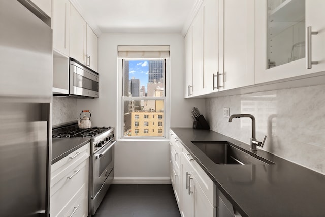 201 E 36th St Unit 17D, New York City, NY 10016 - kitchen with appliances with stainless steel finishes, dark countertops, white cabinets, and backsplash