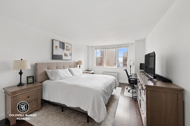 bedroom featuring baseboards and wood finished floors
