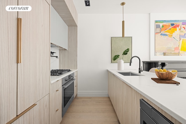1235 Dean St Unit 5, New York City, NY 11216 - kitchen featuring appliances with stainless steel finishes, light wood-type flooring, modern cabinets, pendant lighting, and light stone countertops