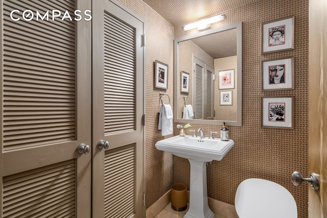 half bath featuring a sink and toilet