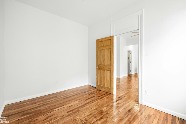 empty room with light wood-style floors and baseboards