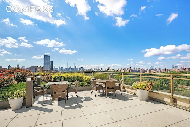 view of patio / terrace featuring a city view and outdoor dining area