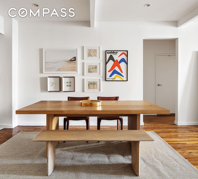 dining room with baseboards and wood finished floors