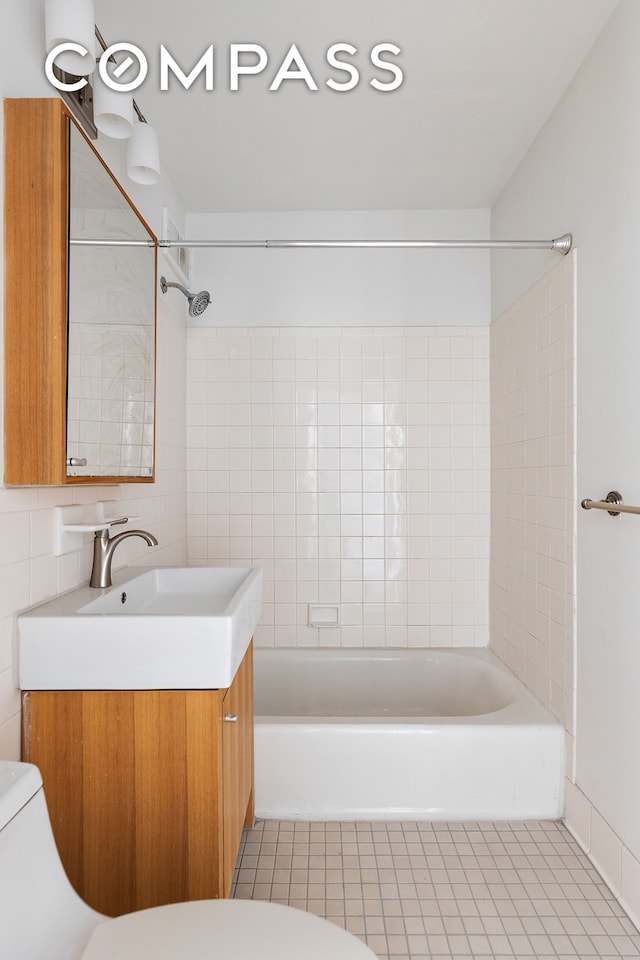 bathroom featuring vanity, tile patterned flooring, toilet, and tub / shower combination