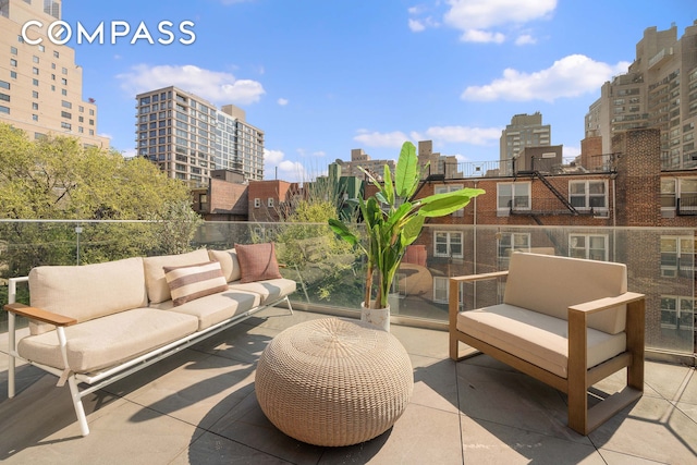 view of patio featuring a view of city and an outdoor living space
