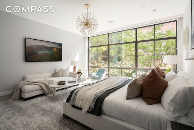 bedroom with baseboards and an inviting chandelier