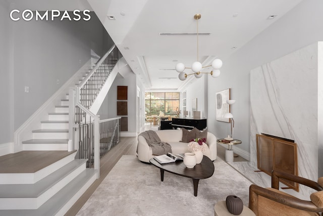 living area with baseboards and stairway