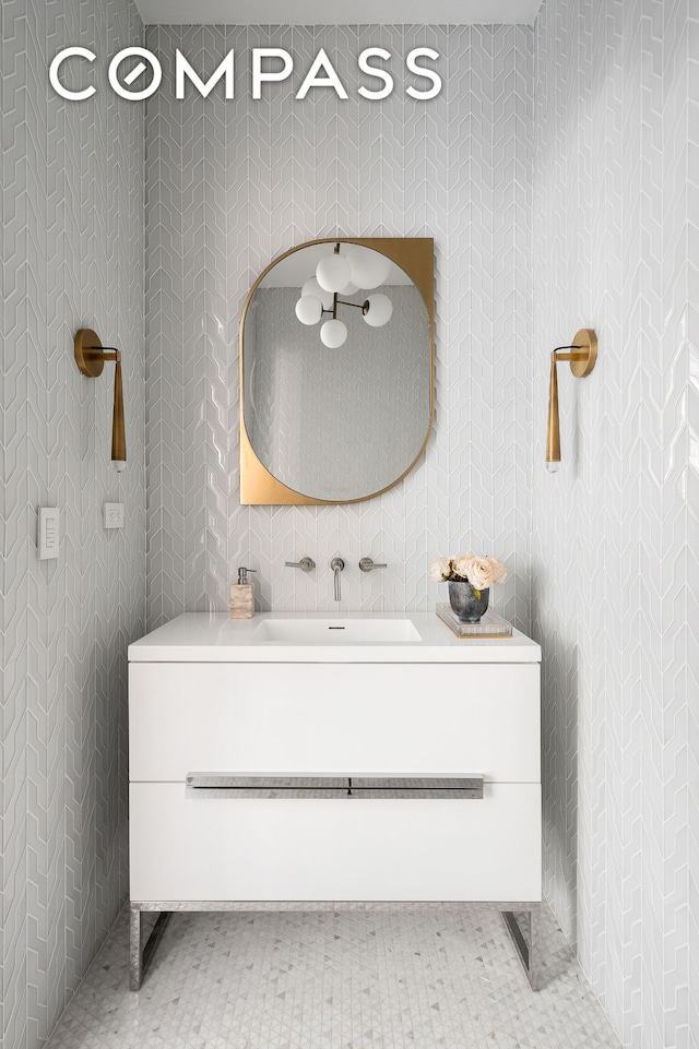 bathroom featuring wallpapered walls and vanity