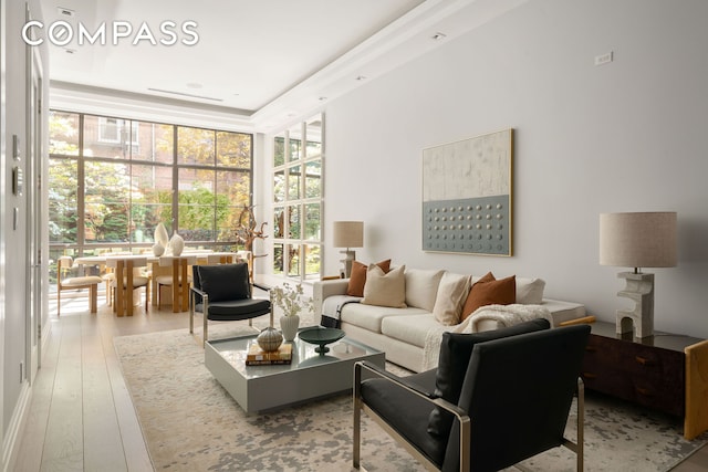 living area with hardwood / wood-style flooring and expansive windows
