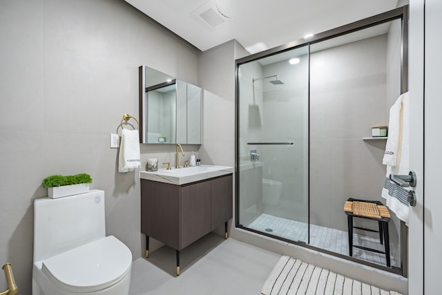 full bathroom featuring vanity, toilet, and a shower stall