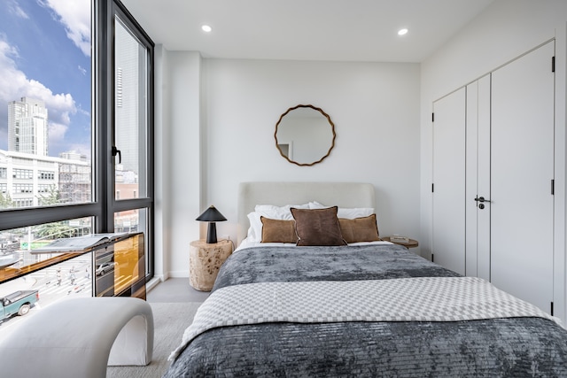 bedroom with recessed lighting and a view of city