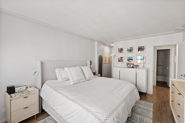 bedroom with dark wood-type flooring and arched walkways
