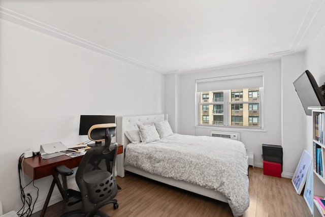 bedroom featuring baseboards and wood finished floors