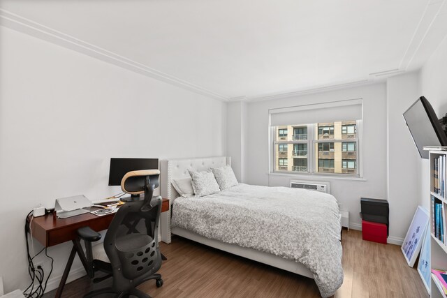 340 E 80th St Unit 17-D, New York City, NY 10075 - bedroom featuring wood finished floors, an office area, and baseboards