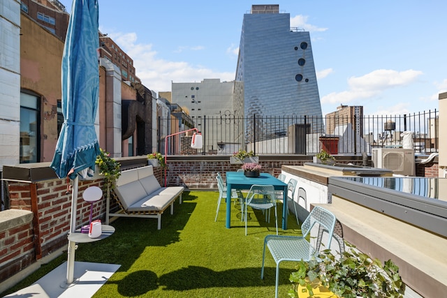 exterior space with ac unit and fence