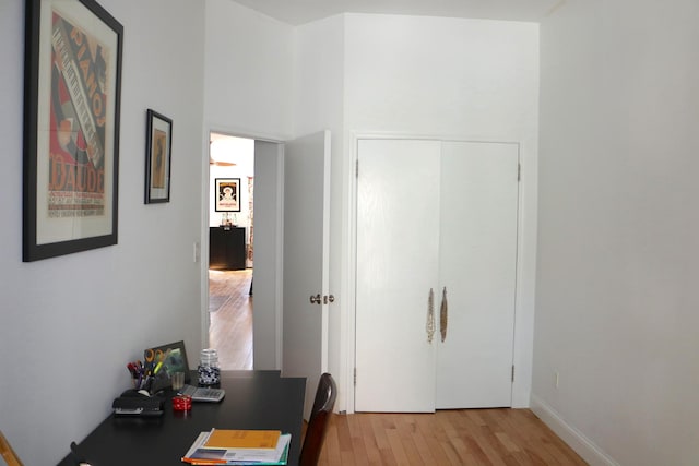 hallway with baseboards and light wood finished floors