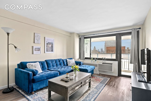 living area featuring wood finished floors and radiator