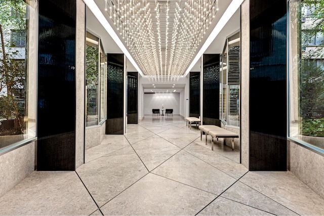 hallway with a chandelier