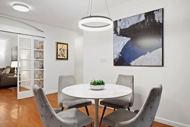 dining room with baseboards and wood finished floors