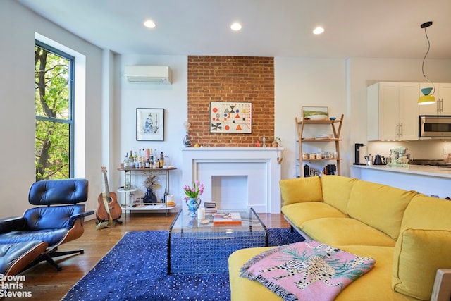 living room featuring recessed lighting, a wall mounted air conditioner, and wood finished floors