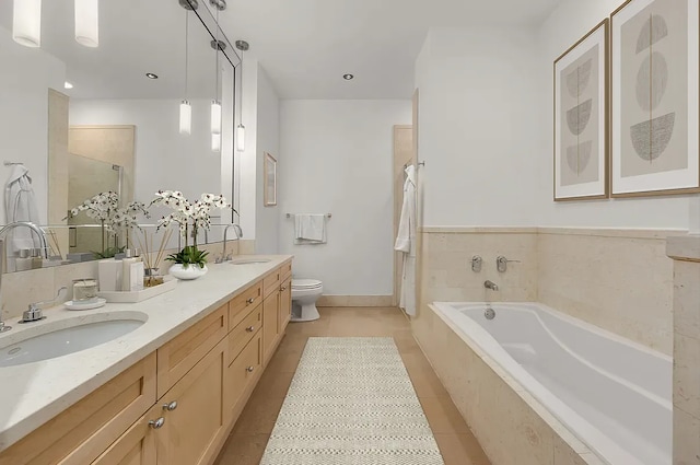 bathroom featuring a garden tub, double vanity, tile patterned floors, toilet, and a shower