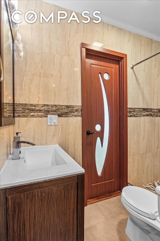 bathroom featuring crown molding, tile walls, vanity, and toilet