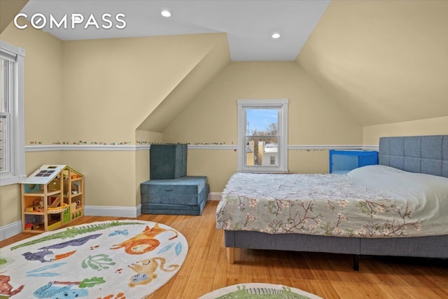 bedroom with baseboards, recessed lighting, wood finished floors, and lofted ceiling