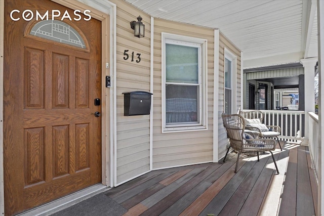 view of exterior entry featuring covered porch