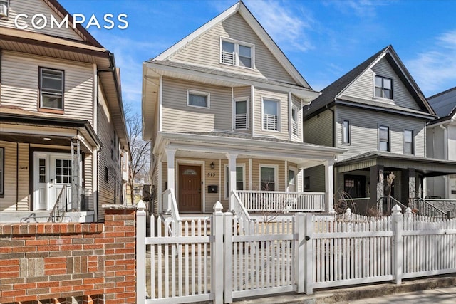 view of front of property featuring a fenced front yard and covered porch